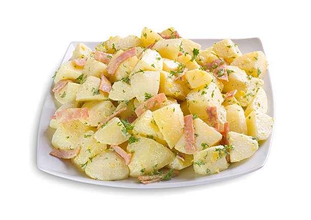 Potato salad on white rectangular plate isolated on white stock photo