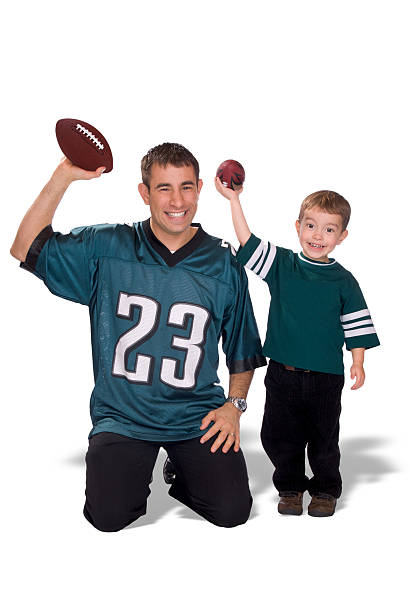 istock Father and Son with footballs wearing jerseys 144876032