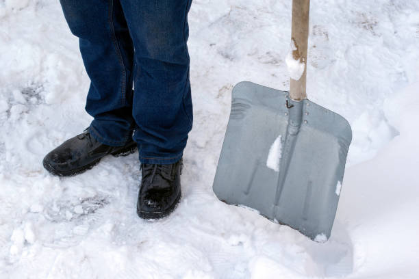 istock Man cleaning snow with shovel in winter day. 1448760391