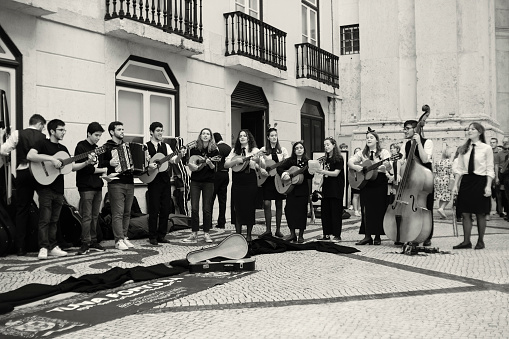 Lisbon, Portugal - October 29, 2022: A group of college students perform at the Rua Augusta street in Lisbon downtown.