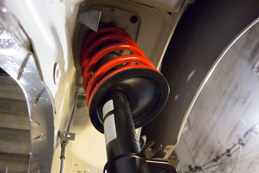 shock absorber in a car to absorb or damp shock impulses