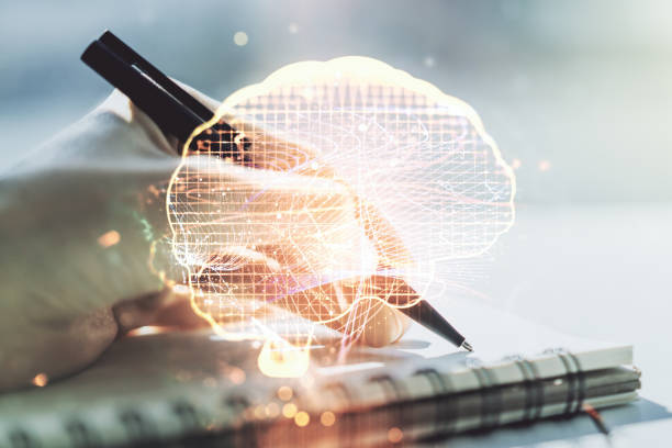 Creative artificial Intelligence concept with human brain hologram and woman hand writing in notebook on background. Multiexposure