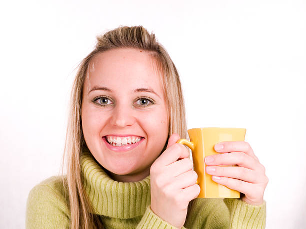 The woman is drinking a tea stock photo