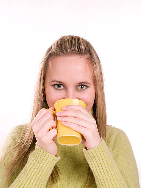 young woman drinking hot tea stock photo