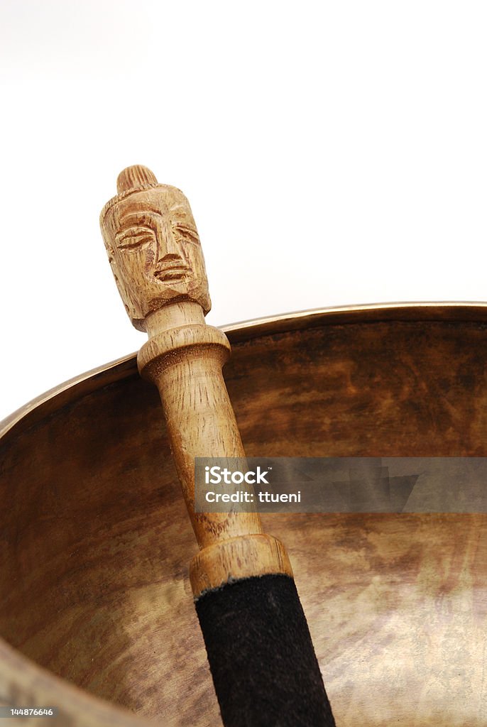 Tibetan Singing Bowl and mallet Tibetan singing bowl with mallet over white background Alloy Stock Photo