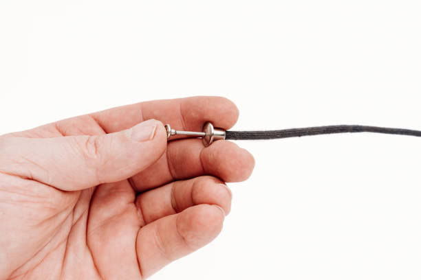 istock Trigger cable in the hand on a white background. photo equipment. 1448766656