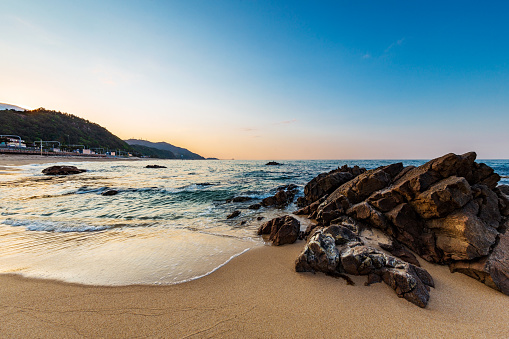 Northern side of Jeongdongjin sandy beach and its rocks at sunset, Gangneung, Gangwon-do,South Korea.