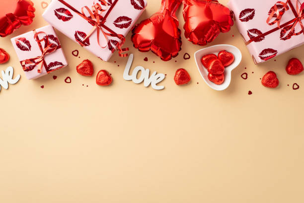 valentine's day concept. top view photo of gift boxes in wrapping with kiss lips pattern heart shaped balloons plate candies inscription love confetti on isolated light beige background with copyspace - valentines day candy chocolate candy heart shape imagens e fotografias de stock