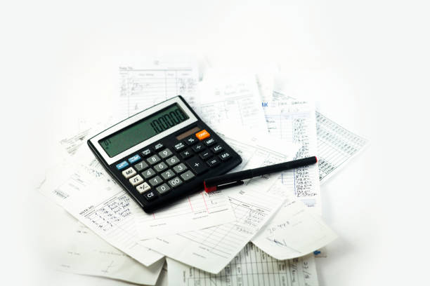istock Business desk with calculator, notebook, and bills. Copy space website banner concept 1448768274