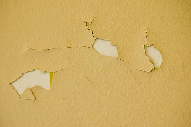 istock Cracked paint on wall with three holes 144876934