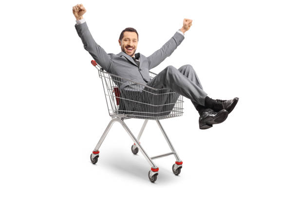 istock Businessman sitting inside a shopping cart and gesturing happiness 1448769961