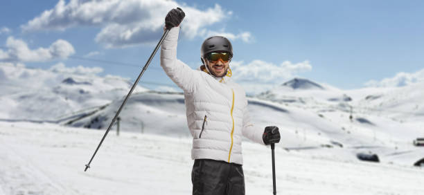 istock Man with skis lifting a skiing pole on a mountain 1448769967