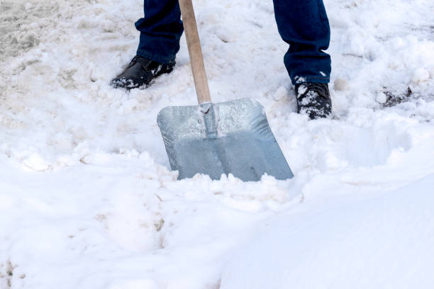 istock A man cleans snow with a metal shovel 1448774378