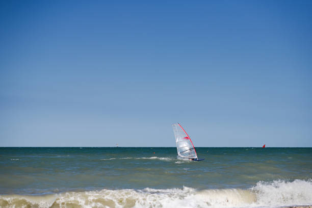 istock Windsurfer on a good riding waves at sea. 1448774658