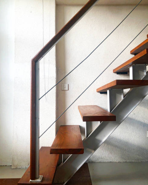 istock Wooden Staircase on White Wall 1448775011