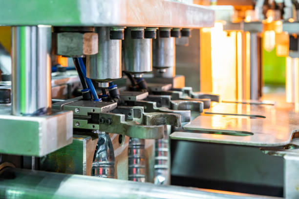 istock Close up pneumatic gripper for hold preform plastic pet bottle making on bottle blowing machine for manufacturing process in industrial 1448778864