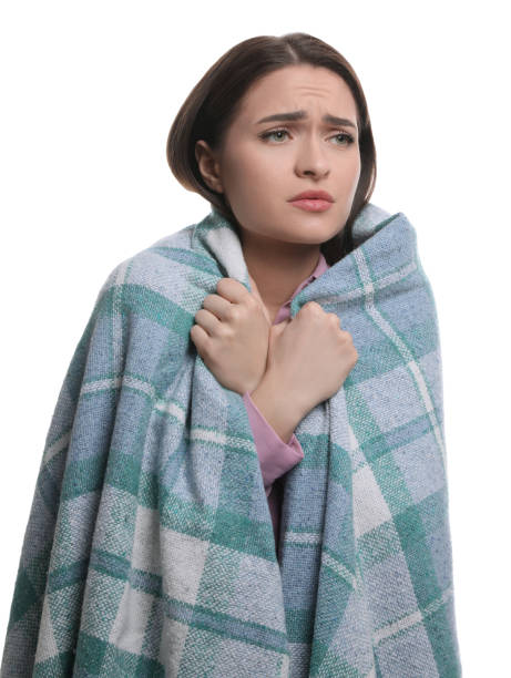 istock Woman wrapped in blanket suffering from cold on white background 1448780340