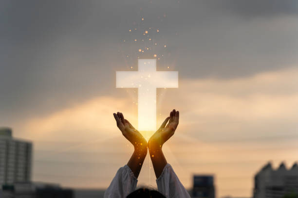 Silhouette of human hands palm up praying and worship of cross, eucharist therapy bless god helping, belief, forgiveness, freedom Silhouette of human hands palm up praying and worship of cross, eucharist therapy bless god helping, belief, forgiveness, freedom, hope and faith, christian religion concept on sunset background. church like a holy light from god stock pictures, royalty-free photos & images