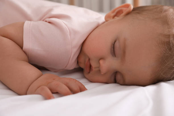 istock Adorable little baby sleeping on bed, closeup 1448781262