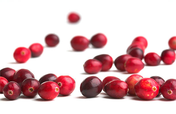 Fresh cranberries spread out in a white background stock photo