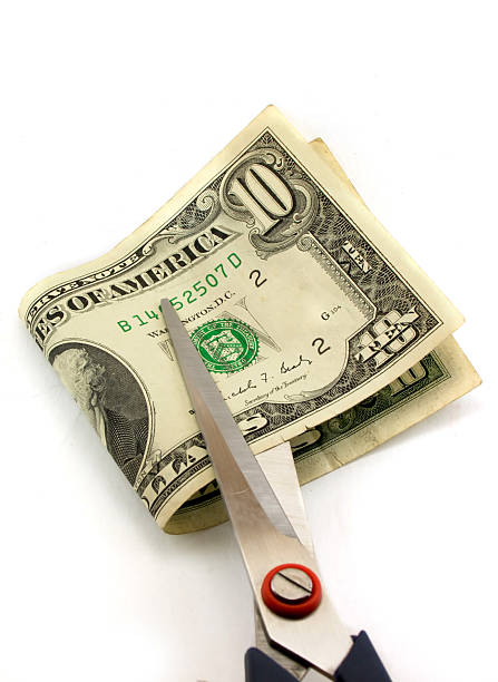 istock Cutting of money by scissors 144878237