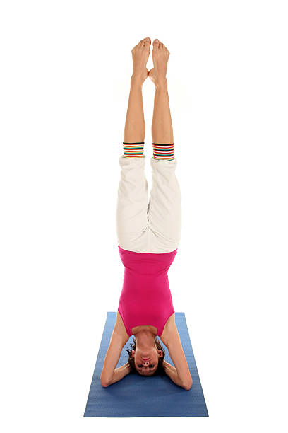 istock Woman Doing Headstand On Yoga Mat 144878481