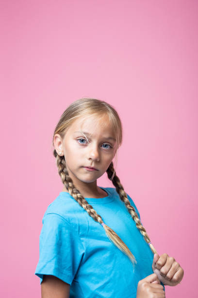 istock Blonde little girl with braids looking at camera 1448785553