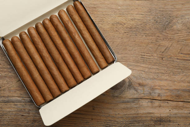 istock Humidor with cigars on wooden table, top view. Space for text 1448786761
