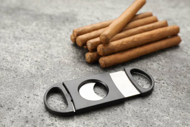 istock Many cigars and guillotine cutter on grey table 1448786792