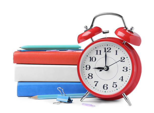istock Red alarm clock and different stationery on white background. School time 1448788026