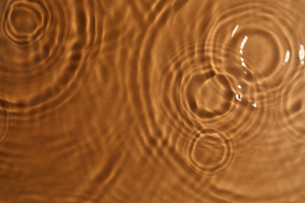 istock Closeup view of water with circles on brown background 1448788072