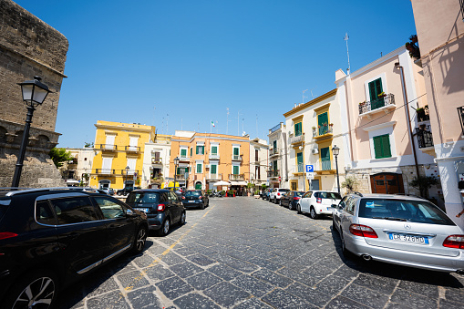 Bari, Italy - Jule 19, 2022: Lots of tightly parked cars near Swabian castle or Castello Svevo, a medieval landmark of Apulia.