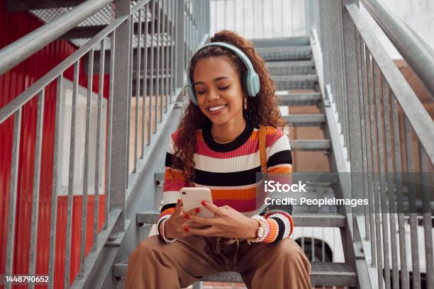 Phone Headphones And Black Woman On Stairs In City Streaming Music Audio Or Radio Gen Z Earphones And Brazilian Student On 5g Mobile Texting Or Internet Surfing Social Media Or Web Browsing Stock Photo - Download Image Now