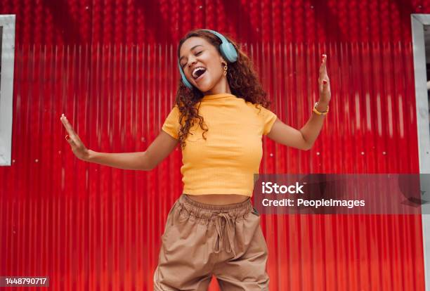 Headphones Black Woman And Happy Dance In City Against Red Building Background Music Dancing And Carefree Female Dancer In Brazil Laughing Singing And Streaming Audio Or Radio On Wireless Headset Stock Photo - Download Image Now