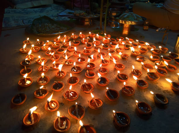 istock Happy Diwali - Diya lamps lit during diwali celebration 1448790732