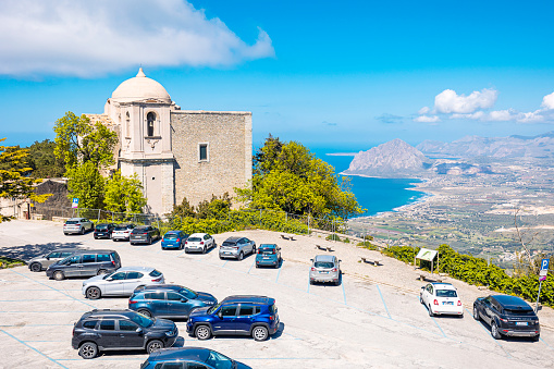 Erice, an atmospheric ancient town on top of a hill. The northern part of the island of Sicily. View of the Church of San Giovanni Battista and the coastline towards the Monte Cofano hill.