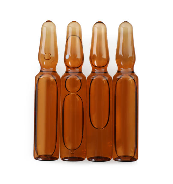 istock Glass ampoules with pharmaceutical product on white background, top view 1448792776