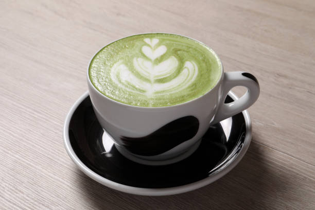 istock Cup of fresh matcha latte on wooden table 1448793090