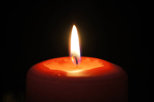red candle cropped on black background - advent electric item lights bildbanksfoton och bilder