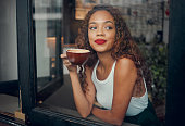 Happy black woman, relax in cafe with smile at window and drinking coffee or tea thinking about future. Young African American girl in a coffee shop, latte drink and creative idea inspiration