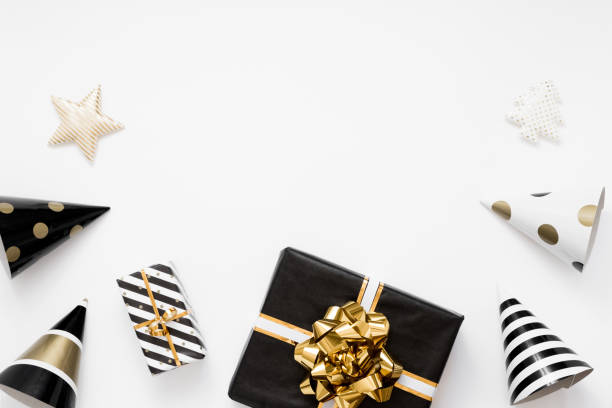 Christmas flatlay. Christmas gifts, black and golden decorations on white background. Flat lay, top view, copy space stock photo