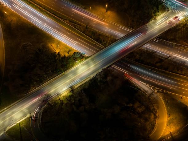 istock Aerial view of an exit ramp of a highway at night 1448806341