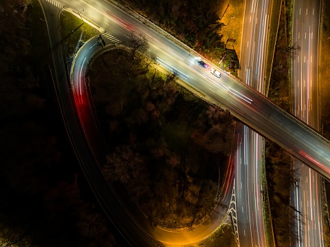 An aerial view of an exit ramp of a highway at night