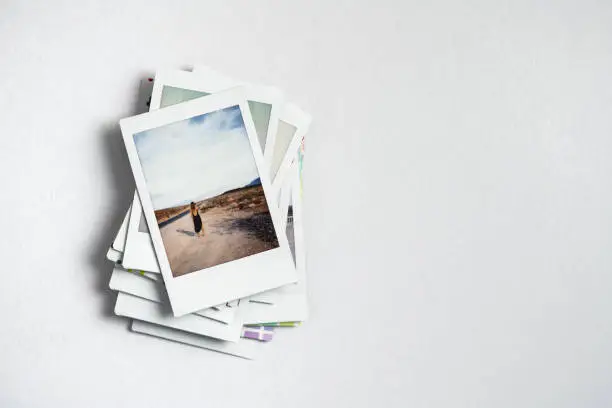 Stack of retro polaroid photos from a trip with copy space - Travel memories concept
