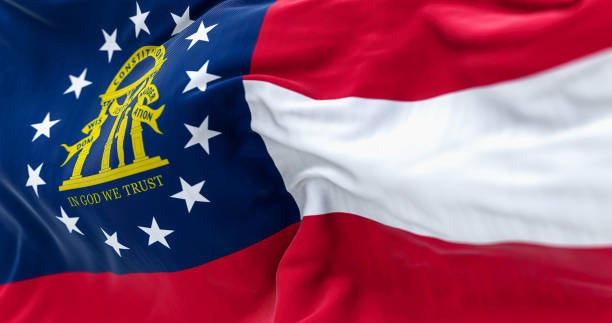 Close-up view of the Georgia state flag waving in the wind Close-up view of the Georgia state flag waving in the wind. Georgia is a federated state of the United States of America. Fabric textured background. Selective focus. Realistic 3d illustration georgia us state photos stock pictures, royalty-free photos & images