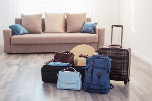 suitcases packed for travel on  living room floor