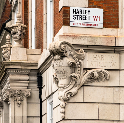 London, UK - Signs on a street corner on Harley Street in London, famous for being the traditional location of prestigious medical clinics.