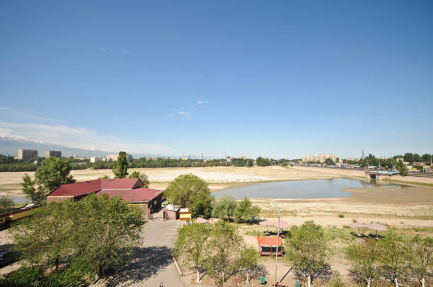 Almaty City with the man made Sayran Lake (dry). The image shows a residential district of Almaty City with the dry Sayran water Reservoir, capture during summer season