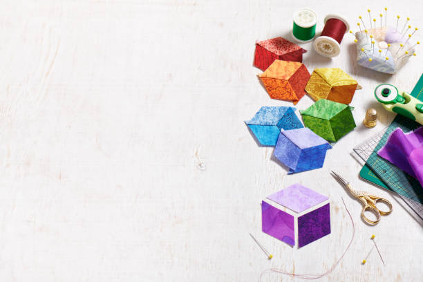 istock Three diamonds, which will be sewn in the form of a cube, which will become a component of the quilt, quilting and sewing accessories. 1448816977