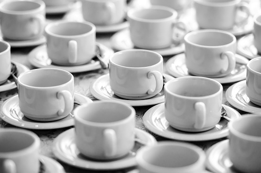 abstract background from many rows of coffee or tea cups, selective focus